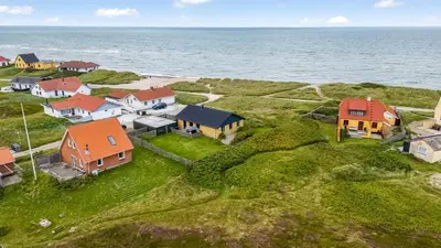 an aerial view of a house on the ocean at Lovely Holiday Home With Panoramic Views Of The North Sea in Frøstrup