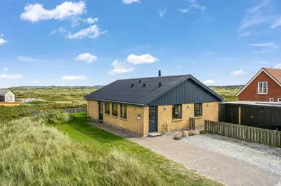 a brick house with a black roof at Lovely Holiday Home With Panoramic Views Of The North Sea in Frøstrup
