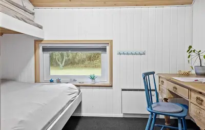 a bedroom with a bed and a desk and a window at Cozy Home In Spøttrup With Wifi in Spottrup