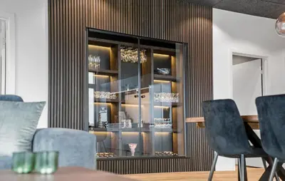 a dining room with a glass cabinet with chandeliers at 3 Bedroom Stunning Home In Løgstrup in Løgstrup
