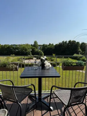 a black table and chairs on a patio at Stor og Lys Lejlighed i Hjertet af Holstebro in Holstebro