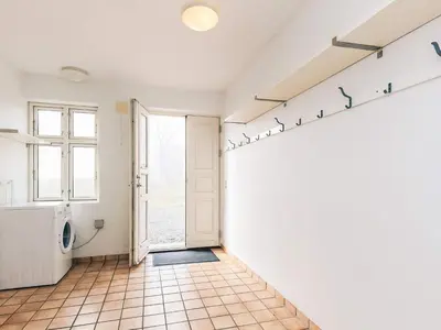 a room with a white wall with birds on a shelf at 8 person holiday home in Roslev in Roslev