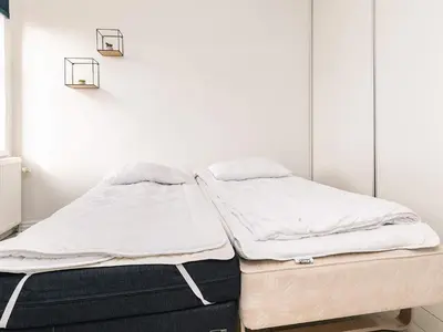 two beds sitting next to each other in a room at 8 person holiday home in Roslev in Roslev