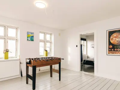 a room with a game table in the middle of it at 8 person holiday home in Roslev in Roslev