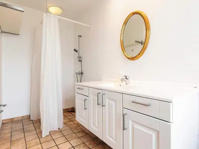 a bathroom with a white sink and a mirror at 8 person holiday home in Roslev in Roslev