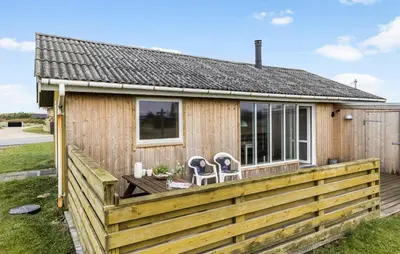 a small wooden house with a wooden fence at 2 Bedroom Cozy Home In Thisted in Thisted