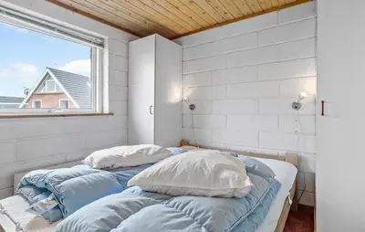 two beds in a room with a window at 2 Bedroom Cozy Home In Thisted in Thisted