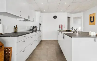 a white kitchen with white cabinets and a sink at Cozy Home In Hanstholm With Wifi in Hanstholm
