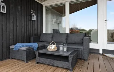 a patio with a couch and a table on a porch at 3 Bedroom Nice Home In Roslev in Roslev