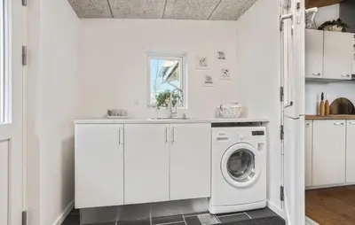 a white laundry room with a washer and dryer at 3 Bedroom Nice Home In Roslev in Roslev