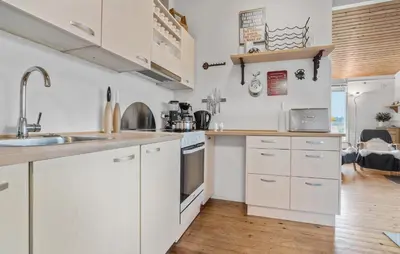 a kitchen with white cabinets and a sink at 3 Bedroom Nice Home In Roslev in Roslev