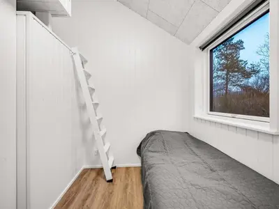 a bedroom with a bed and a window at Holiday Home Grimar - 400m to the fjord by Interhome in Vemb
