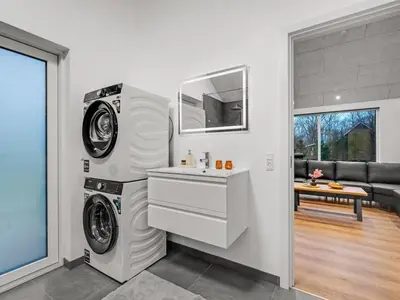 a laundry room with a washer and dryer and a sink at Holiday Home Grimar - 400m to the fjord by Interhome in Vemb