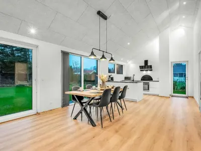 a dining room and kitchen with a table and chairs at Holiday Home Grimar - 400m to the fjord by Interhome in Vemb