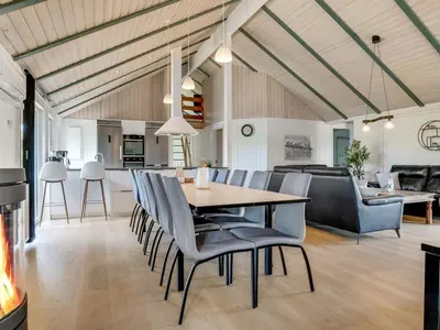 a dining room and living room with a table and chairs at Holiday Home Eftim - 500m from the sea by Interhome in Harboør
