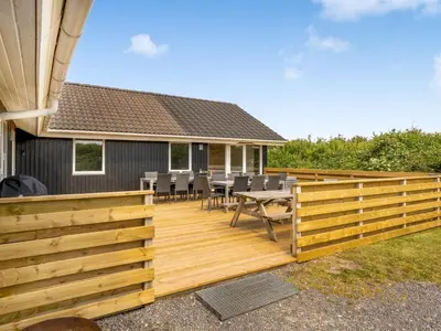 a deck with chairs and a table on a house at Holiday Home Eftim - 500m from the sea by Interhome in Harboør