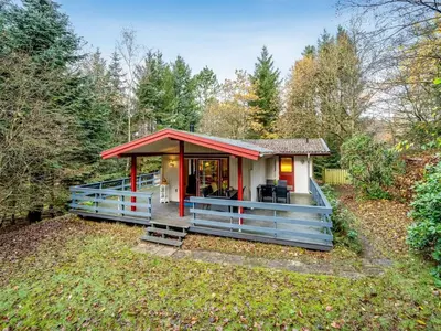a tiny house with a red roof in the woods at Holiday Home Ennignup - 600m to the fjord by Interhome in Højslev