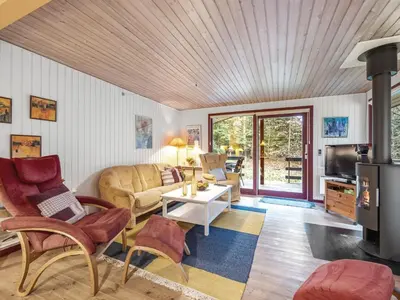 a living room with a couch and a table at Holiday Home Ennignup - 600m to the fjord by Interhome in Højslev