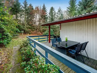a deck with a table and chairs on it at Holiday Home Ennignup - 600m to the fjord by Interhome in Højslev