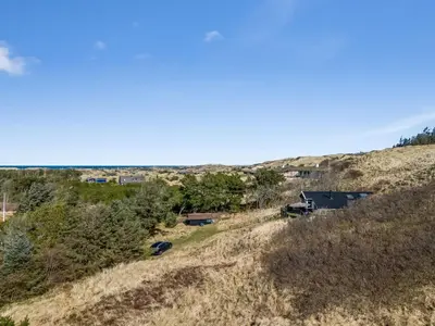an aerial view of a hill with a house on it at Holiday Home Sella - 600m from the sea by Interhome in Blokhus
