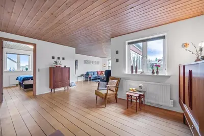 a living room with a wooden ceiling at Lovely Holiday House With 4 Rooms Close To The North Sea in Frøstrup