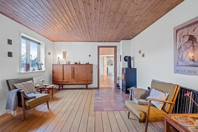 a living room with a wooden ceiling at Lovely Holiday House With 4 Rooms Close To The North Sea in Frøstrup