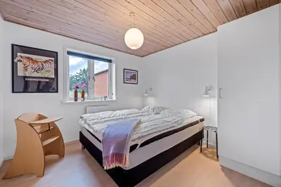 a bedroom with a bed and a window at Lovely Holiday House With 4 Rooms Close To The North Sea in Frøstrup