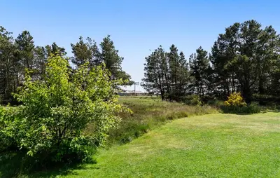 a path through a field with trees in the background at Beautiful Home In Vestervig With Sauna in Vestervig