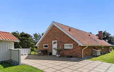 a brick house with a patio in front of it at Beautiful Home In Vestervig With Sauna in Vestervig