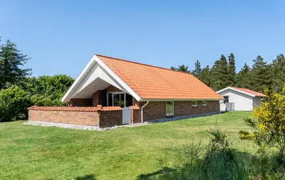 a house with an orange roof on a yard at Beautiful Home In Vestervig With Sauna in Vestervig