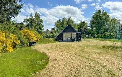 a barn in the middle of a field at 2 Bedroom Amazing Home In Spøttrup in Spottrup