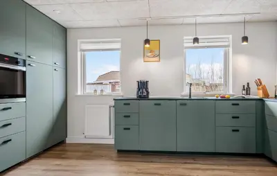 a kitchen with green cabinets and a window at Amazing Home In Vestervig With Wifi in Vestervig