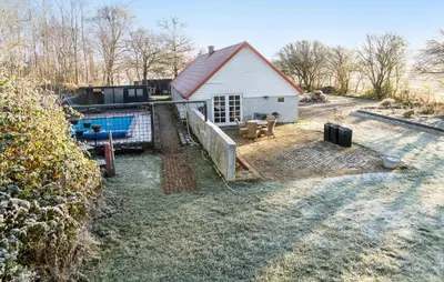 a house with a swimming pool in front of it at Pet Friendly Home In Karby in Karby