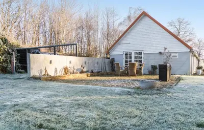 a house with a retaining wall in the yard at Pet Friendly Home In Karby in Karby