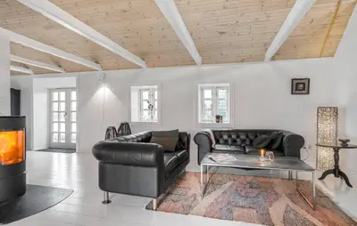 a living room with a leather couch and a table at Pet Friendly Home In Karby in Karby