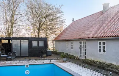 a house with a swimming pool next to a building at Pet Friendly Home In Karby in Karby