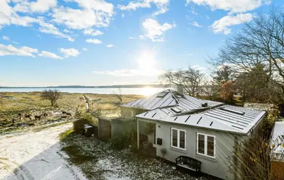 a house with a tin roof on top of it at 3 Bedroom Cozy Home In Nibe in Nibe