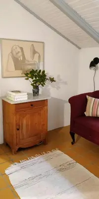 a living room with a couch and a table with a plant at Charming Summer House From 1945 in Sønder Ydby