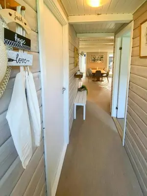 a hallway of a tiny house with a door at Familievenligt Hus Nær Tranum Klitplantage in Pandrup