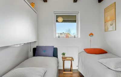 two beds in a small room with a window at Amazing Home In Lemvig in Lemvig