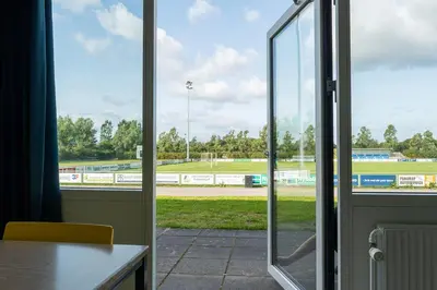 an open glass door with a view of a race track at Jetsmark Idrætscenter in Pandrup