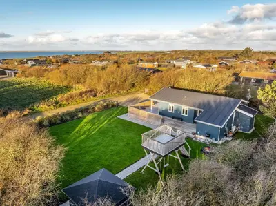 an aerial view of a house with a green yard at Beautiful Holiday Home With A Lovely View Of The Fjord And The Sea in Vestervig
