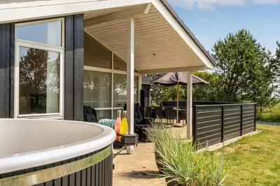 a house with a bath tub in the yard at Lovely Holiday Home With Wilderness Bath And Space For 8 People in Pandrup