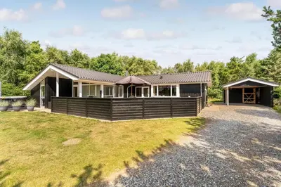 a house with a large yard in front of it at Lovely Holiday Home With Wilderness Bath And Space For 8 People in Pandrup
