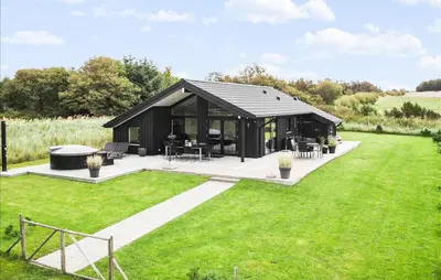 a black pavilion in a field with green grass at Amazing Home In Fjerritslev in Fjerritslev