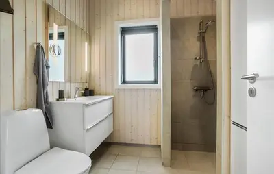 a bathroom with a toilet and a sink and a shower at Amazing Home In Fjerritslev in Fjerritslev