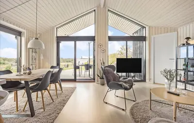a dining room with a table and chairs and a tv at Amazing Home In Fjerritslev in Fjerritslev