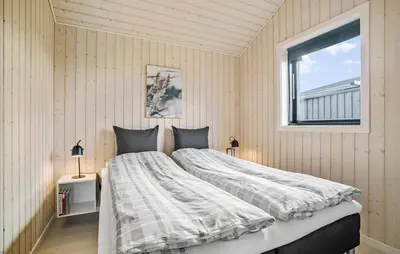 a bedroom with a large bed and a window at Amazing Home In Fjerritslev in Fjerritslev