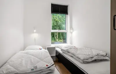 two beds sitting in a room with a window at 2 Bedroom Amazing Home In Hurup Thy in Sønder Ydby