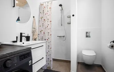 a bathroom with a sink and a toilet and a shower at 2 Bedroom Amazing Home In Hurup Thy in Sønder Ydby